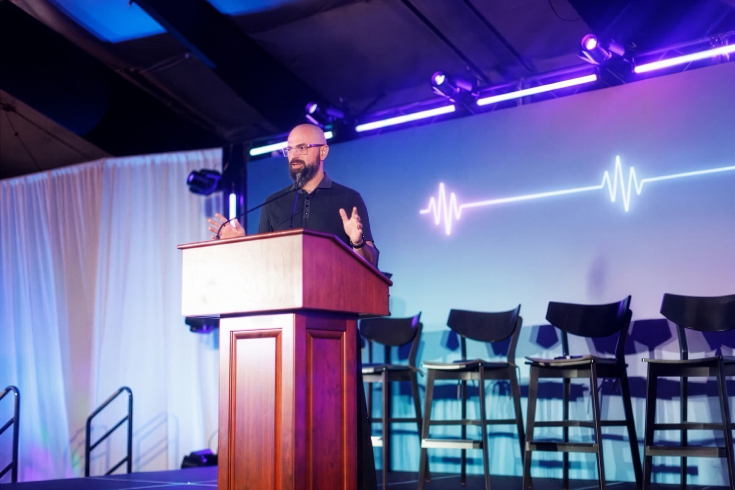 Brennan Gerle delivering an AI keynote on stage